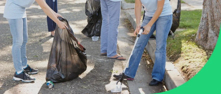 Several Keep Austin Beautiful volunteers picking up trash on a neighborhood street.