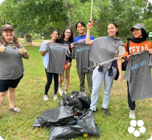 Keep Austin Beautiful volunteers picking up trash at a park on Keep Austin Beautiful Day.