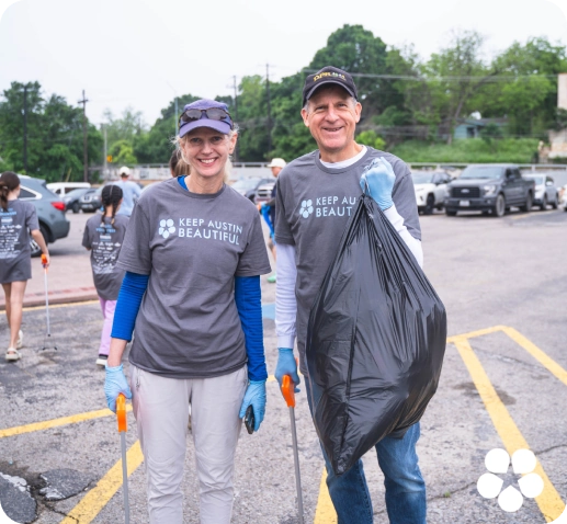 Keep Austin Beautiful volunteers picking up trash at a park on Keep Austin Beautiful Day.