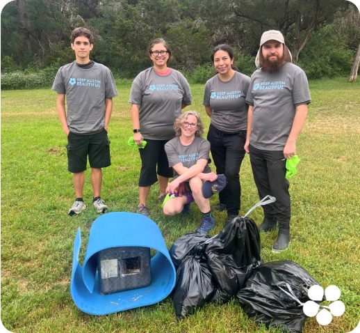 Keep Austin Beautiful volunteers picking up trash at a park on Keep Austin Beautiful Day.