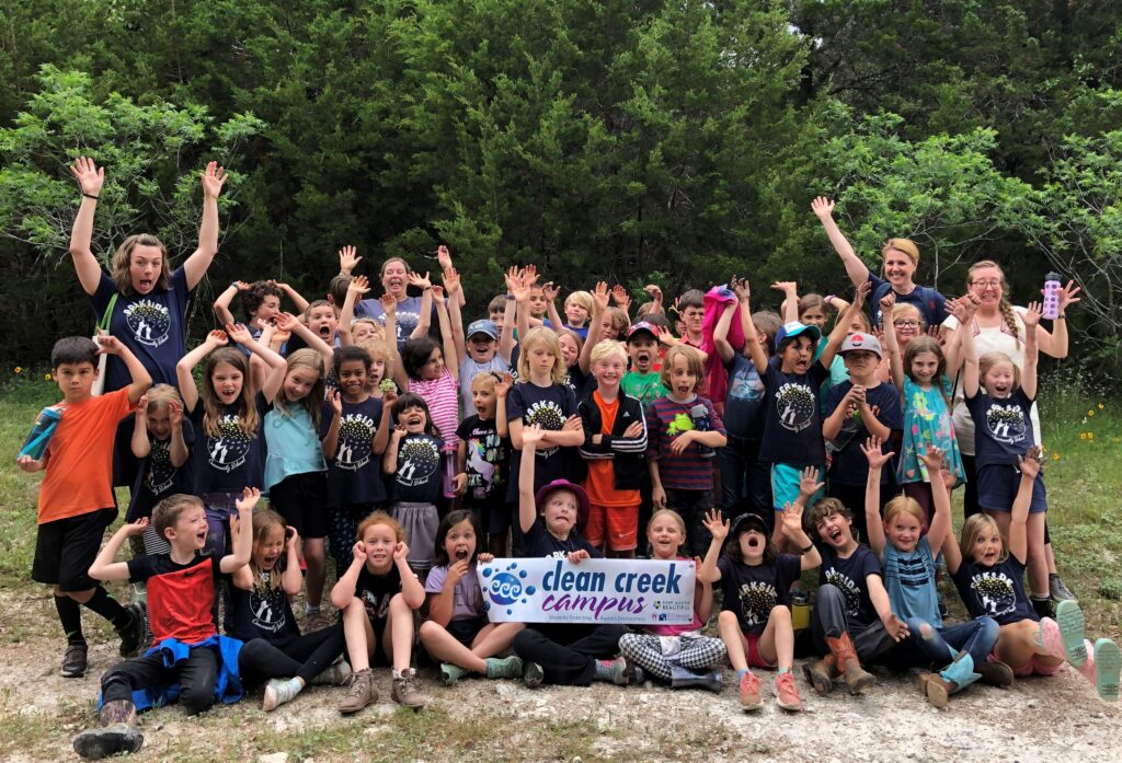 Photo of a group of students holding up a "Clean Creek Campus" sign.