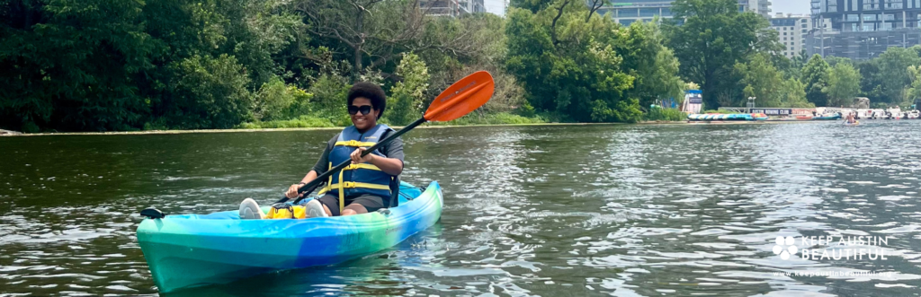 Photo of Sarah Makutu, fellow at Keep Austin Beautiful on a kayak.