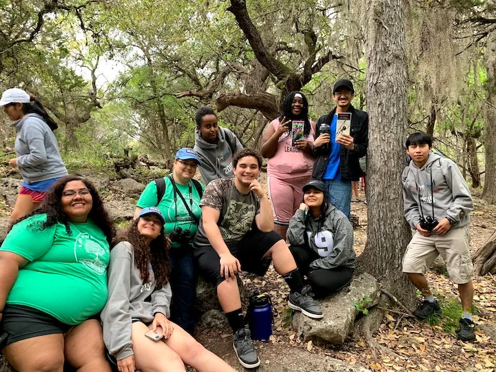 Group of Keep Austin Beautiful volunteers gathered in the woods.