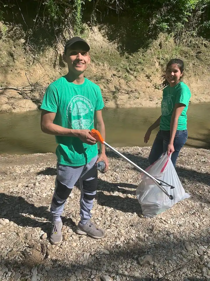 Two volunteers picking up trash at the Greenbelt.