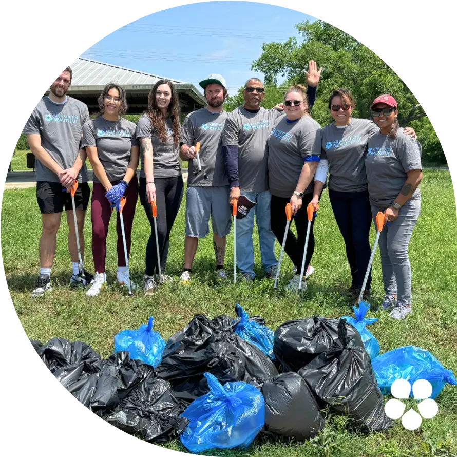 Group of volunteers in a park after a cleanup for Keep Austin Beautiful Day.